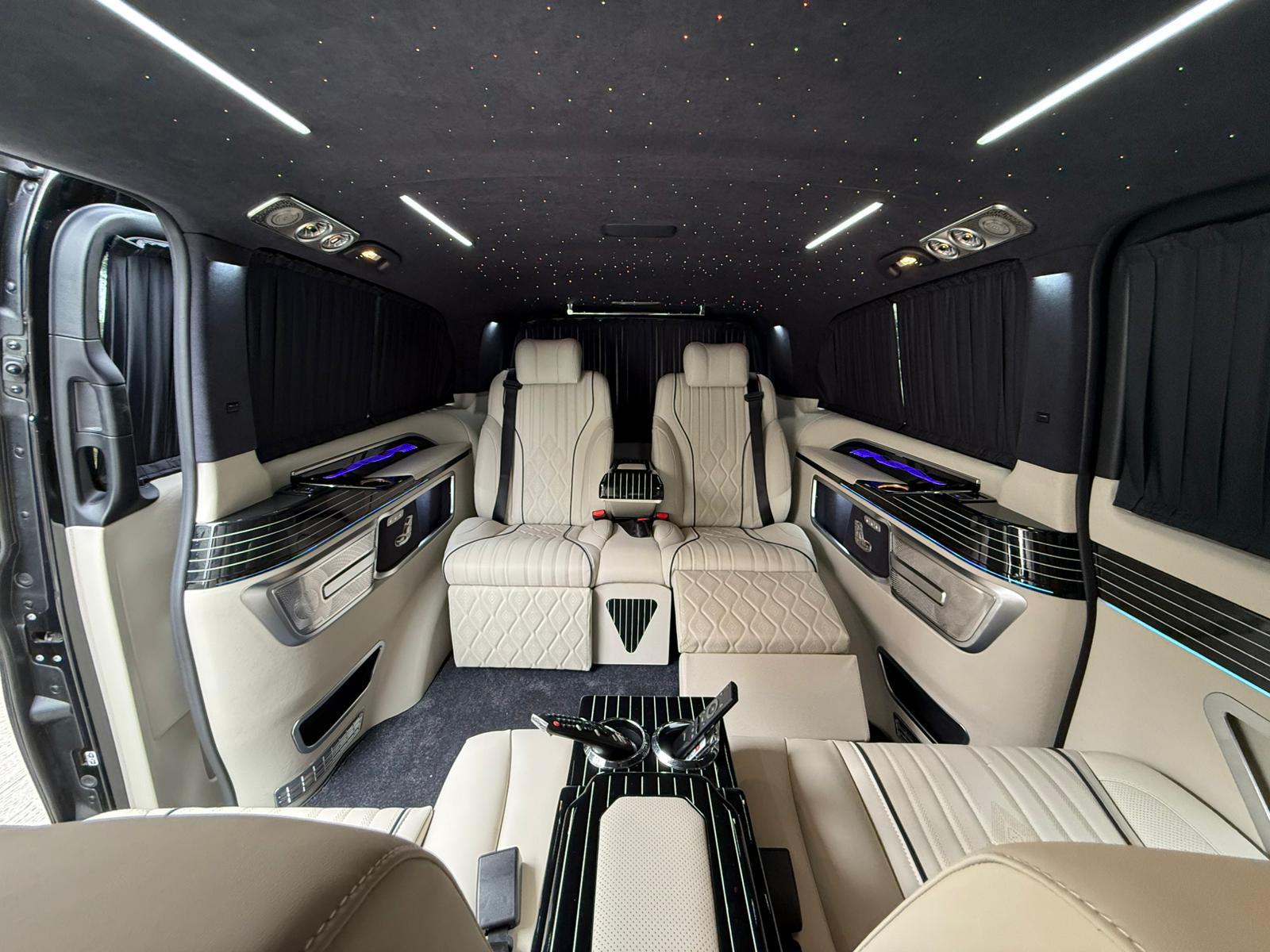 Mercedes Vito VIP interior with starlight ceiling and cream leather captain seats
